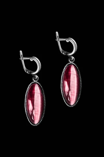 Earrings on black — Stock Photo, Image