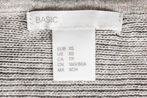 Literami etykietę ubrania — Zdjęcie stockowe