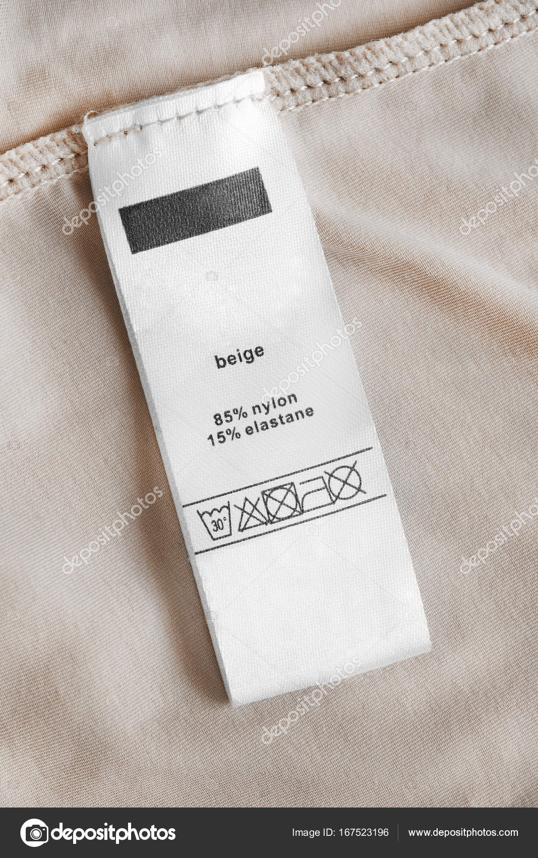 Small Size Clothes Label On Beige Textile Background Stock Photo