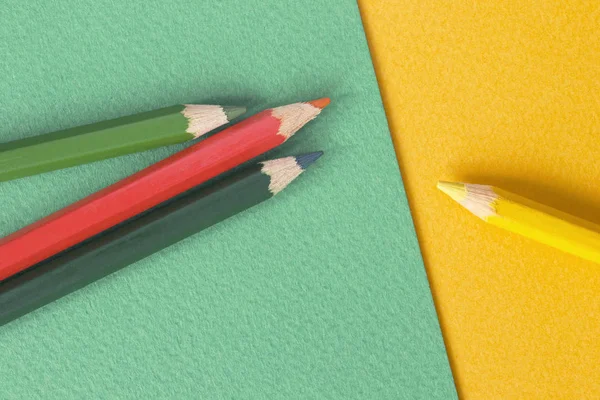 Pencils on colorful paper background — Stock Photo, Image
