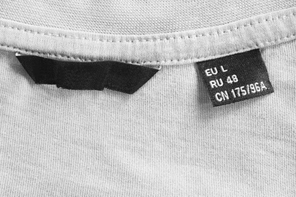 Etiqueta Ropa Talla Sobre Fondo Punto Textil Blanco —  Fotos de Stock