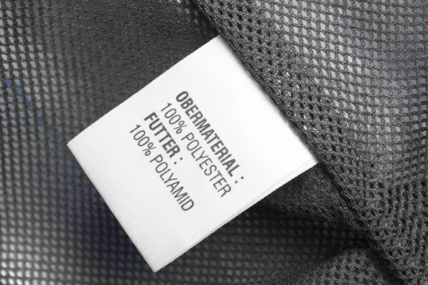 Fabric composition clothes label on grey textile net background