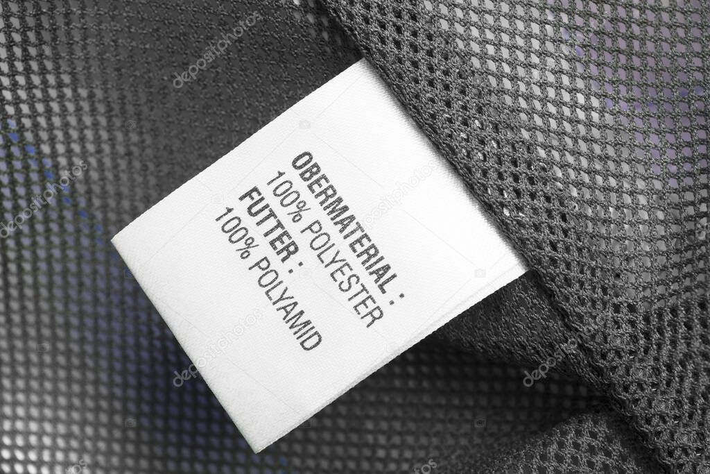 Fabric composition clothes label on grey textile net background