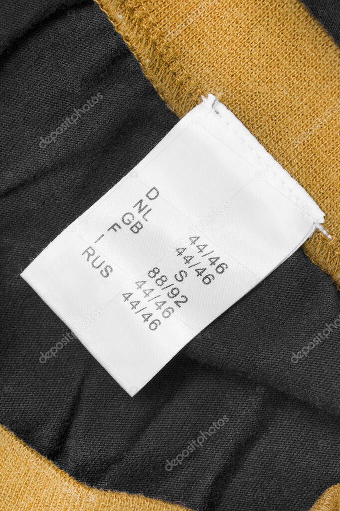 S size clothes label on black and yellow textile background