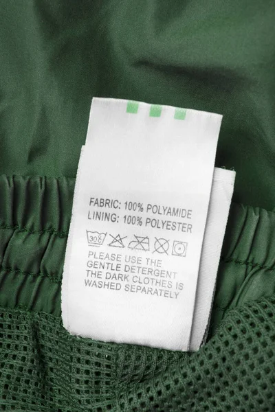Composición Tela Cuidado Etiqueta Ropa Sobre Fondo Textil Verde — Foto de Stock