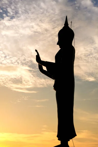 silhouette buddha statue on sunset sky