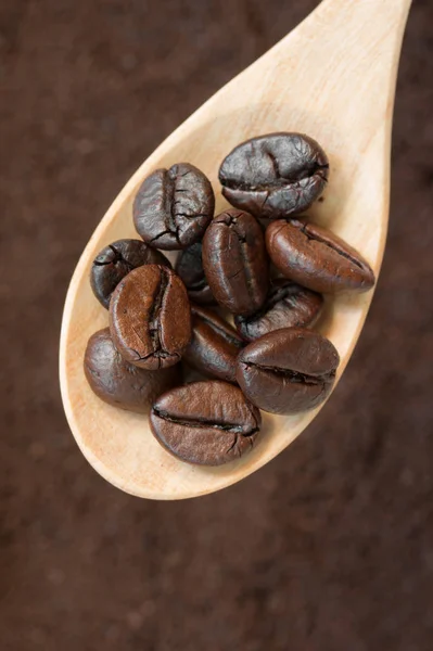 Coffee beans in wooden spoon. — Stock Photo, Image