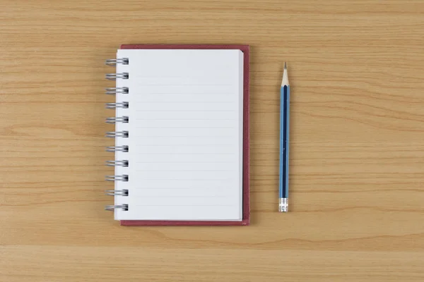 Blank notebook and pencil on wood table. — Stock Photo, Image