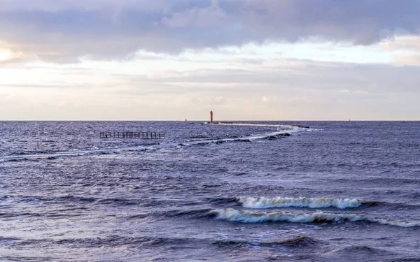 Calm sea background with lighthouse and little waves