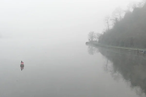 Lake Baldeneysee near Essen in Germany covered in morning fog in autumn