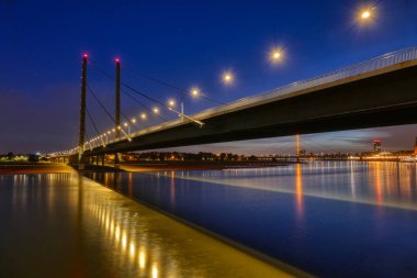 Bridge and Rhine in Duesseldorf in Germany at night clipart