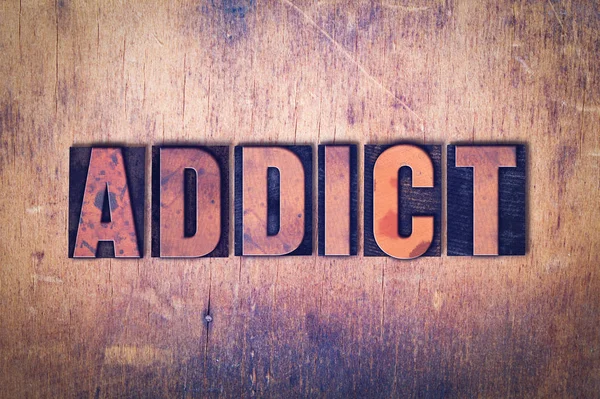 Addict Theme Letterpress Word on Wood Background — Stock Photo, Image