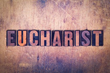 Ahşap arka plan üzerinde Eucharist Tema Letterpress kelime