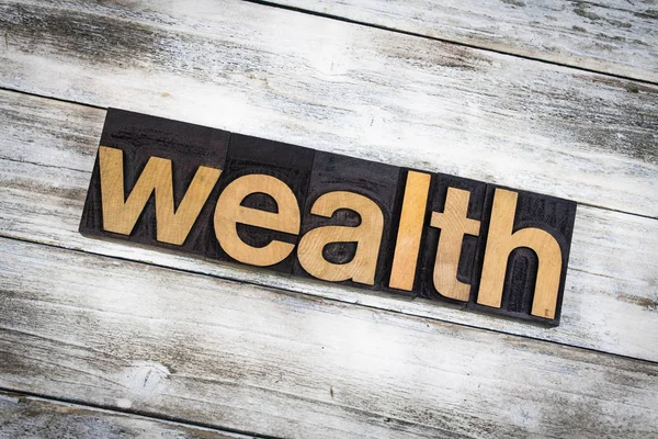 Wealth Letterpress Word on Wooden Background — Stock Photo, Image