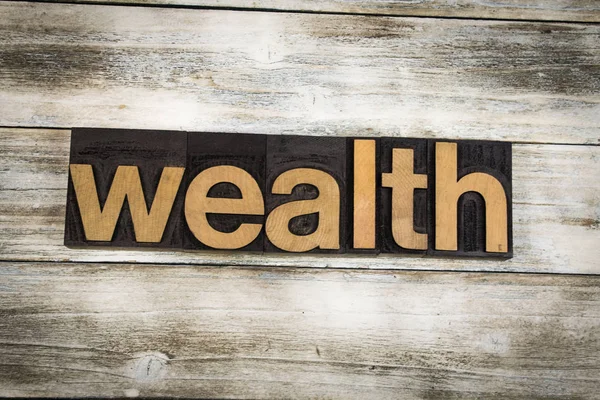 Wealth Letterpress Word on Wooden Background — Stock Photo, Image