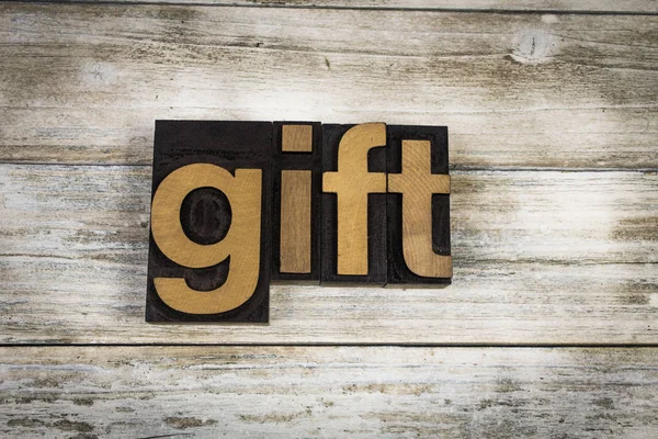 Gift Letterpress Word on Wooden Background — Stock Photo, Image