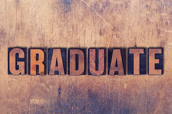 Graduate Theme Letterpress Word on Wood background — стоковое фото