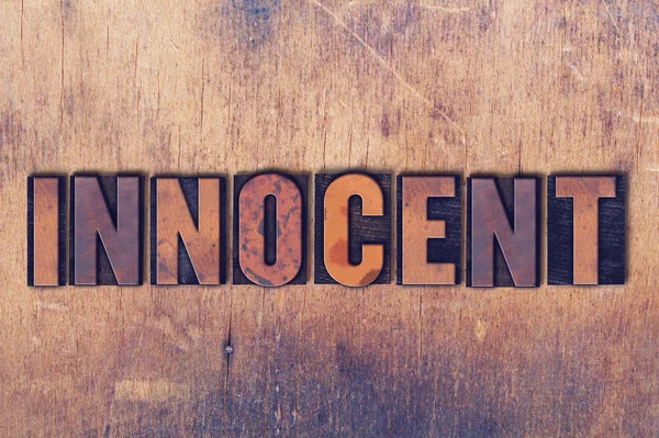 Innocent Theme Letterpress Word on Wood Background — Stock Photo, Image