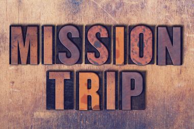 Mission Trip Theme Letterpress Word on Wood Background clipart