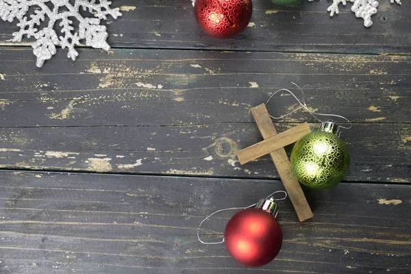 Рождественские украшения и христианский крест на темном дереве — стоковое фото