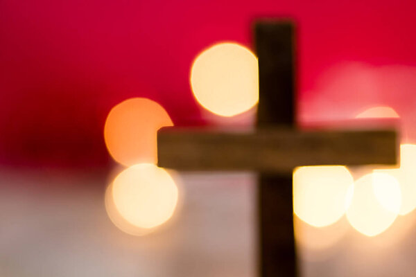 Holy Christian Wooden Cross on an Abstract Red Background