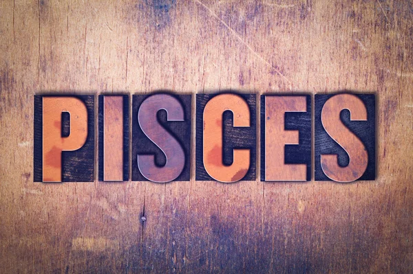 Pisces Theme Letterpress Word on Wood Background — Stock Photo, Image