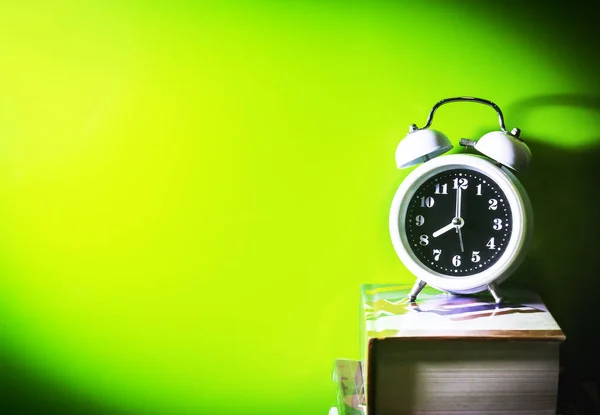 Alarm clock with book — Stock Photo, Image