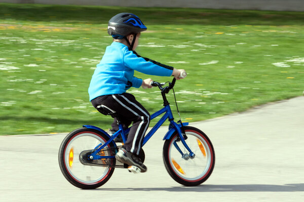 child on a bicycle at asphalt road on traffic playground