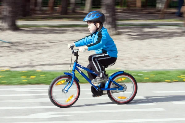 Niño en una bicicleta en la carretera de asfalto en el parque infantil de tráfico — Foto de Stock