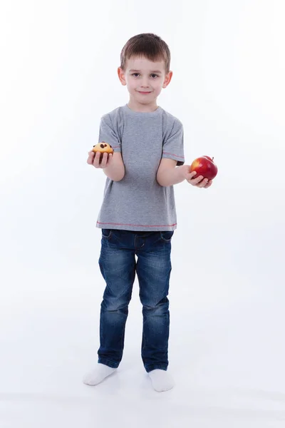 Little boy with food isolated on white background - apple or a muffin — Stock Photo, Image