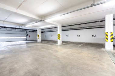 A large empty room - garage parking for cars