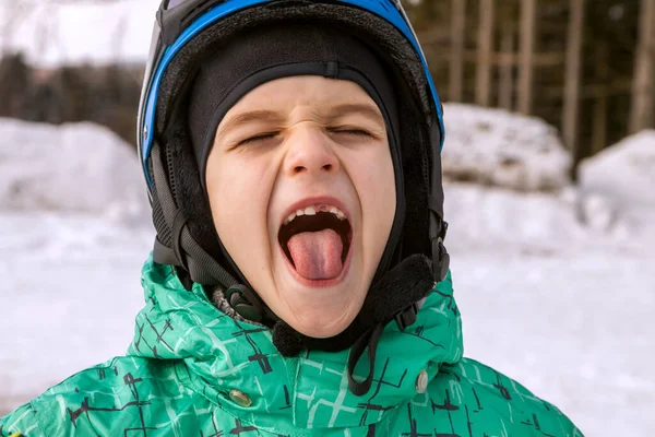 Little boy on mountains in ski helmet with fallen first tooth — Stock Photo, Image