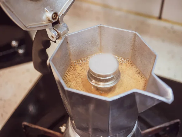 Making black moka coffee using moka coffee maker close-up