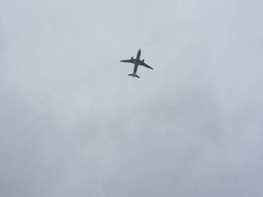 Yolcu jeti silueti bulutlu bir gökyüzüne karşı