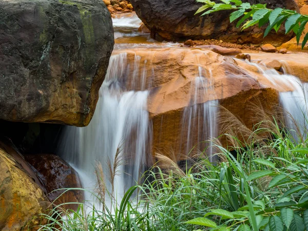 Smooth flowing water falling over rocks