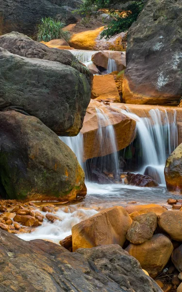 Smooth flowing water falling over rocks