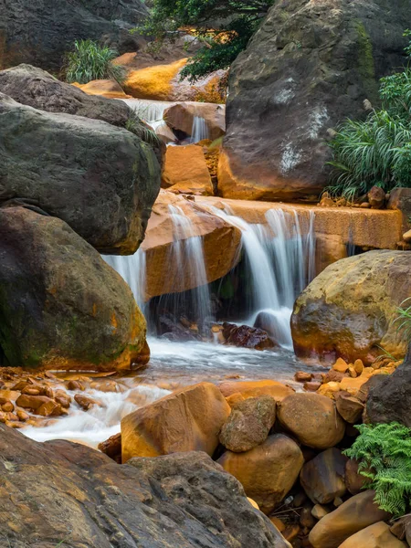 Smooth flowing water falling over rocks