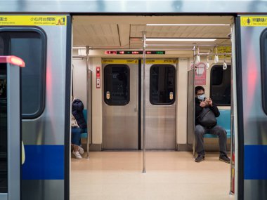Taipei, Tayvan 'da toplu taşıma sisteminde yüz maskesi takan yolcular.