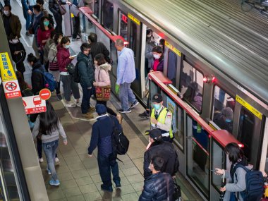 Taipei, Tayvan 'da toplu taşıma sisteminde yüz maskesi takan yolcular.