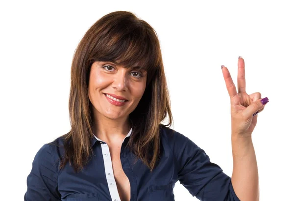Pretty woman doing victory gesture — Stock Photo, Image
