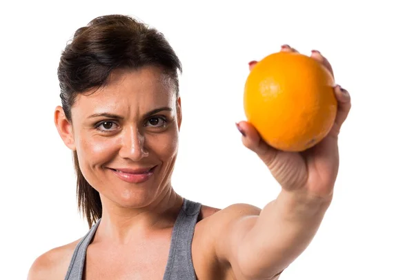 Sport woman with an orange — Stock Photo, Image