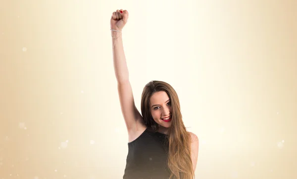 Young girl over ocher background — Stock Photo, Image