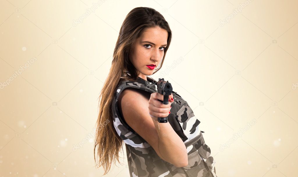 Young girl holding a pistol