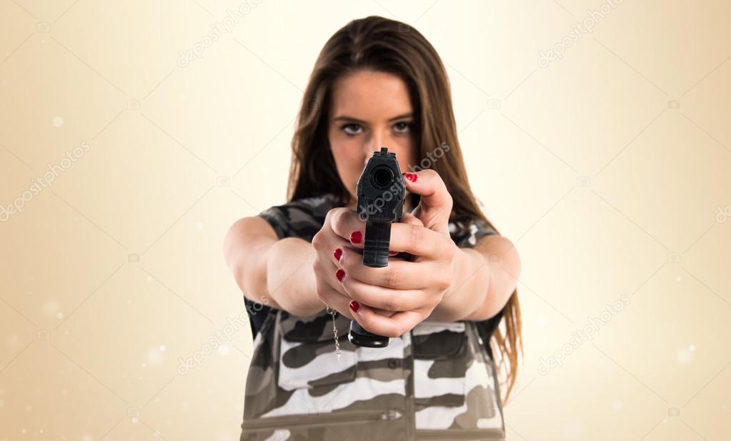 Young girl holding a pistol