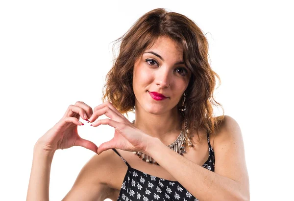 Pretty girl making a heart with her hands — Stock Photo, Image