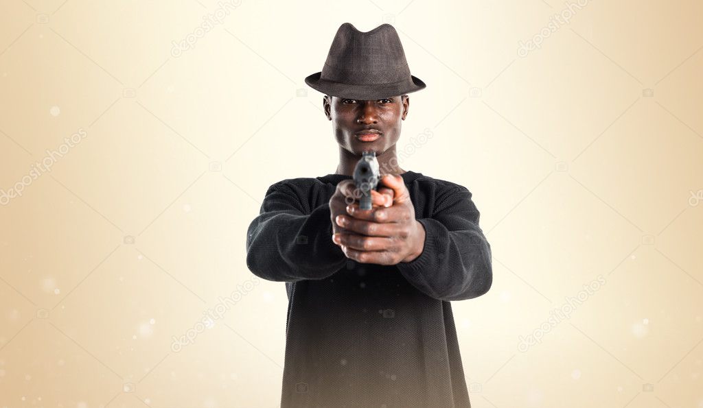 Black man holding a pistol