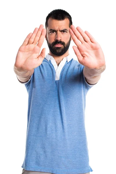 Man with blue shirt making stop sign — Stock Photo, Image