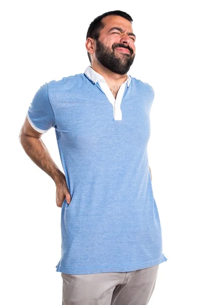 Man met blauw shirt met rugpijn — Stockfoto