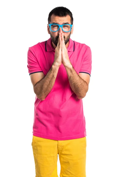 Man with colorful clothes pleading — Stock Photo, Image