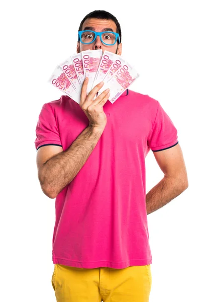 Man met kleurrijke kleding nemen alot of money — Stockfoto